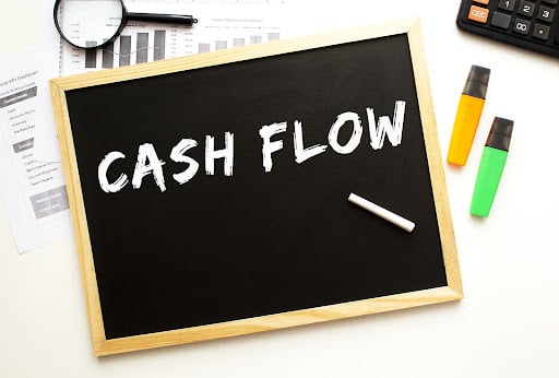 “Cash Flow,” an important real estate investing term to know, written on a chalkboard