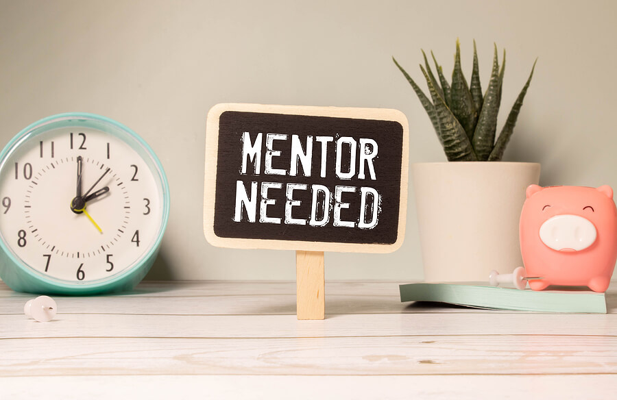black board with the phrase, "mentor needed" written on it