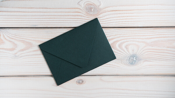 Elegant emerald green post card placed on table