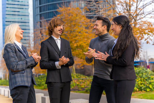 smiling members of real estate investing group laughing in park